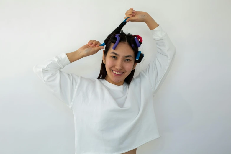 a woman with a pair of hair rollers on her head, inspired by Kim Jeong-hui, pexels contest winner, satisfied pose, maintenance, wavy, asher duran