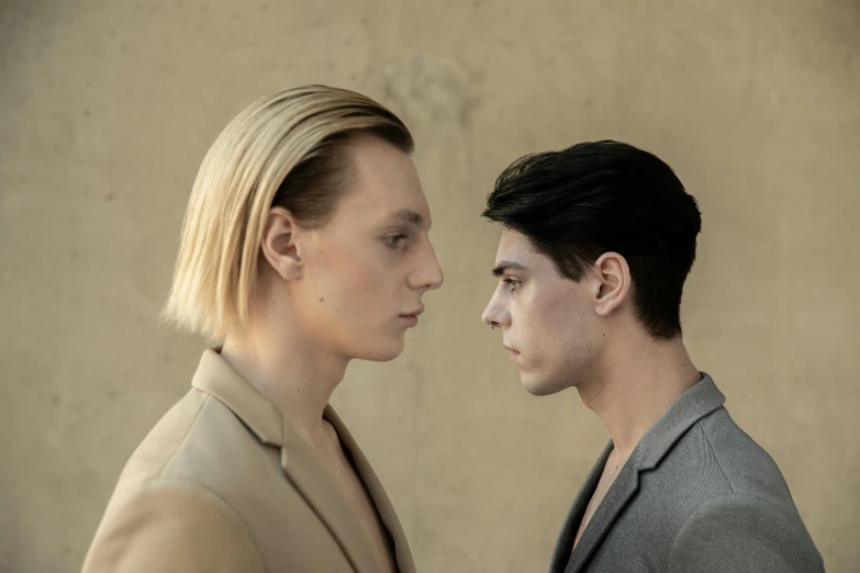 a couple of people standing next to each other, by Emma Andijewska, bauhaus, chiseled jawline, lgbtq, promo image, high quality photo