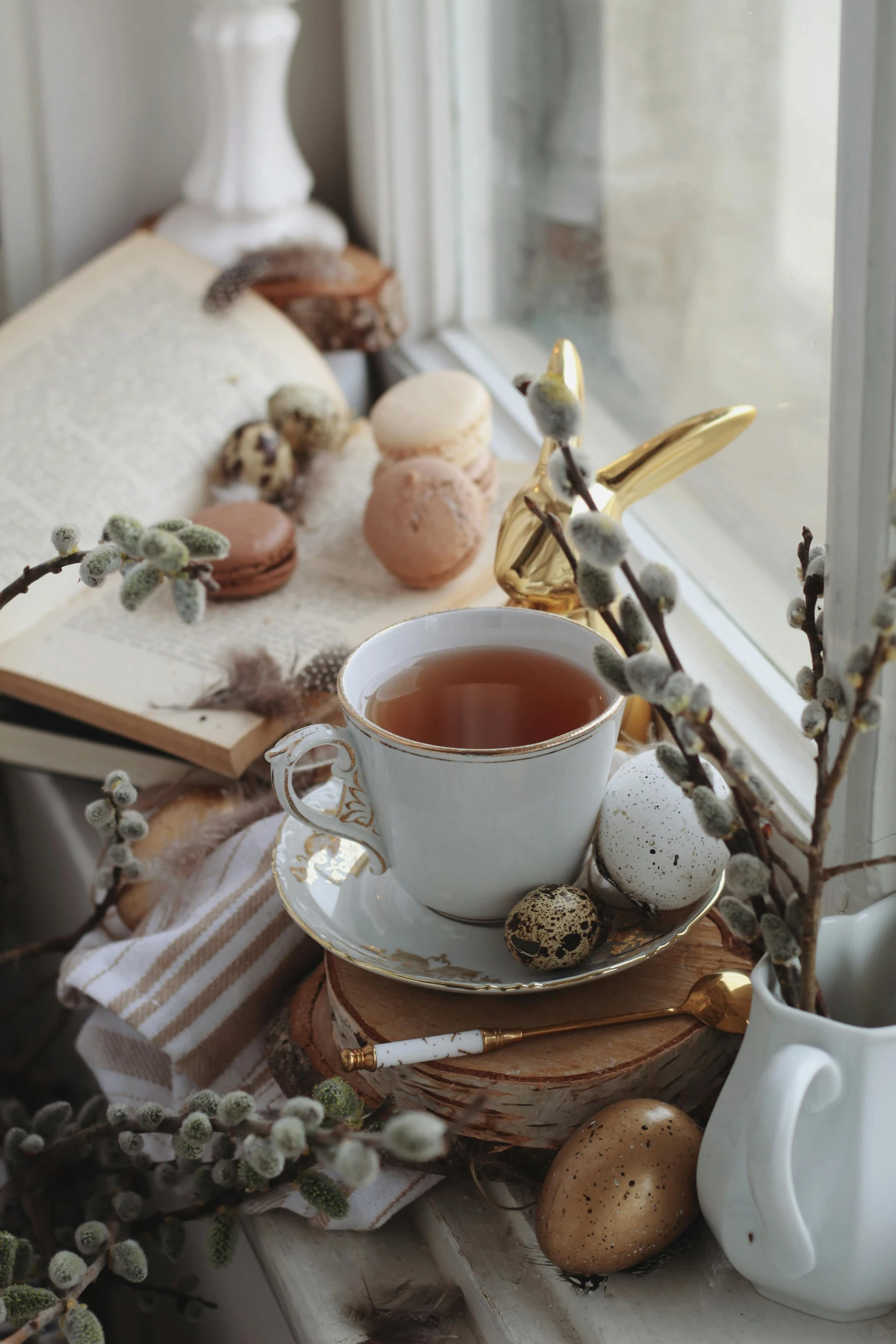 a cup of tea sitting on top of a window sill, a still life, trending on pexels, renaissance, easter, ivory and copper, sitting on a mocha-colored table, stacked image