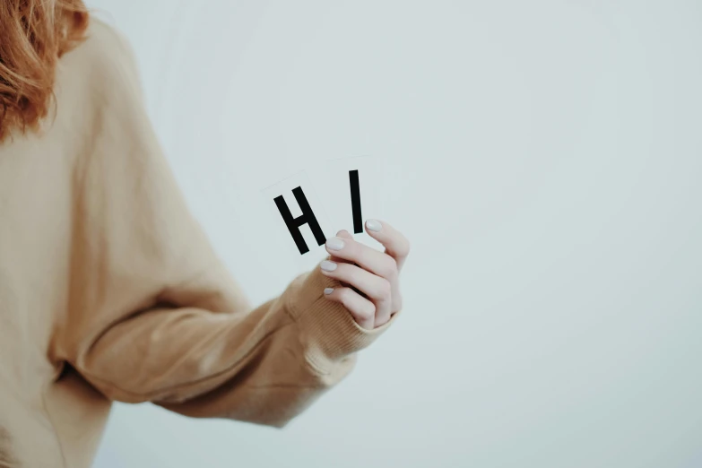 a close up of a person holding a pair of scissors, by Emma Andijewska, unsplash, letterism, hey buddy, with a white background, electrostatic hum, holding a wooden staff