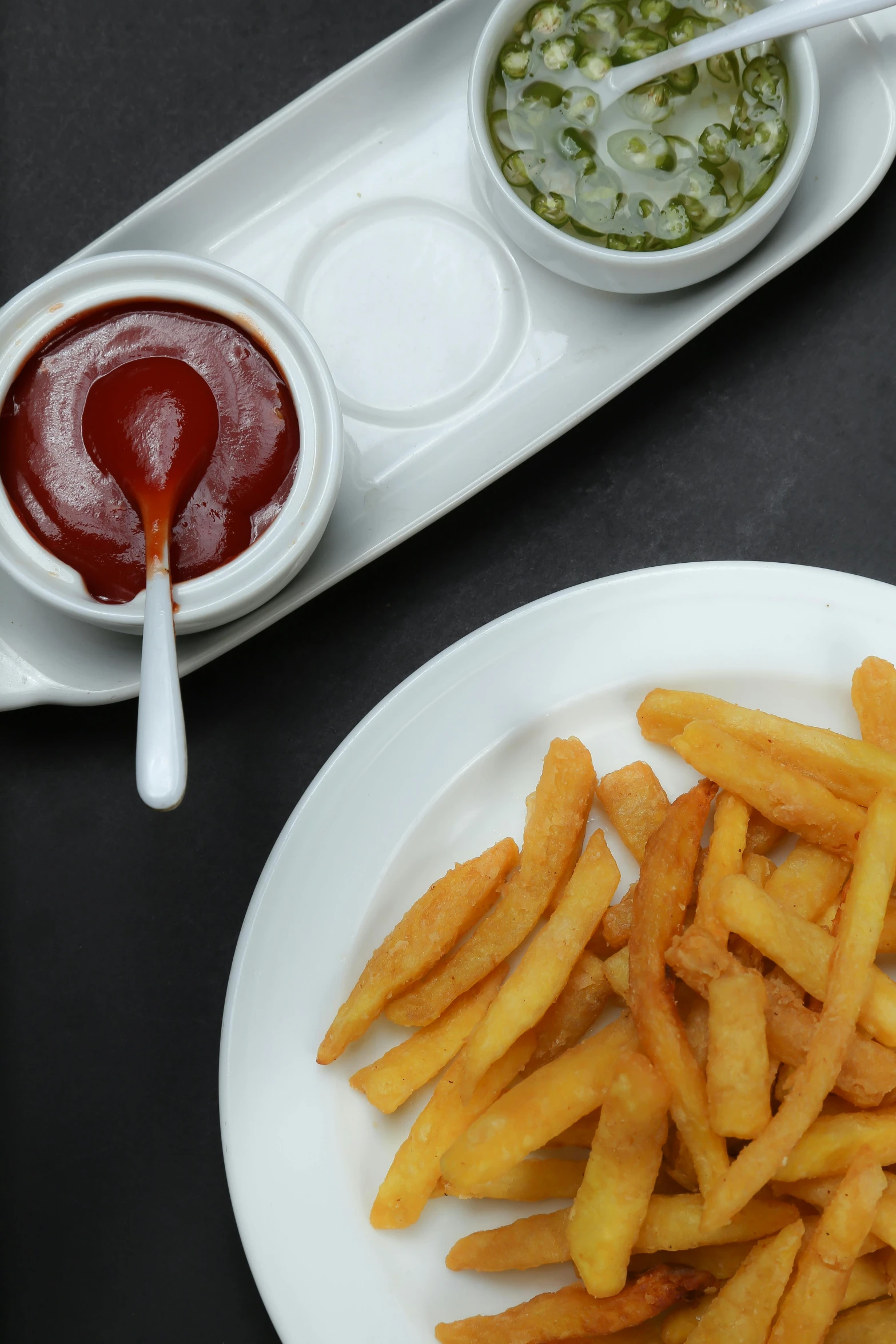 a white plate topped with french fries next to a bowl of ketchup, caparisons, thumbnail, jaime jasso, hillside