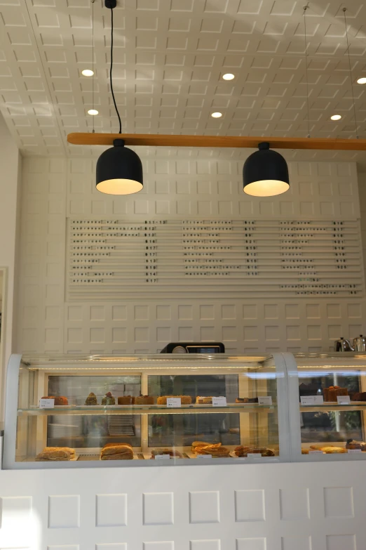 a bakery filled with lots of pastries and pastries, by Hannah Tompkins, art nouveau, simple ceiling, restaurant menu photo, interior white wall, upon a peak in darien