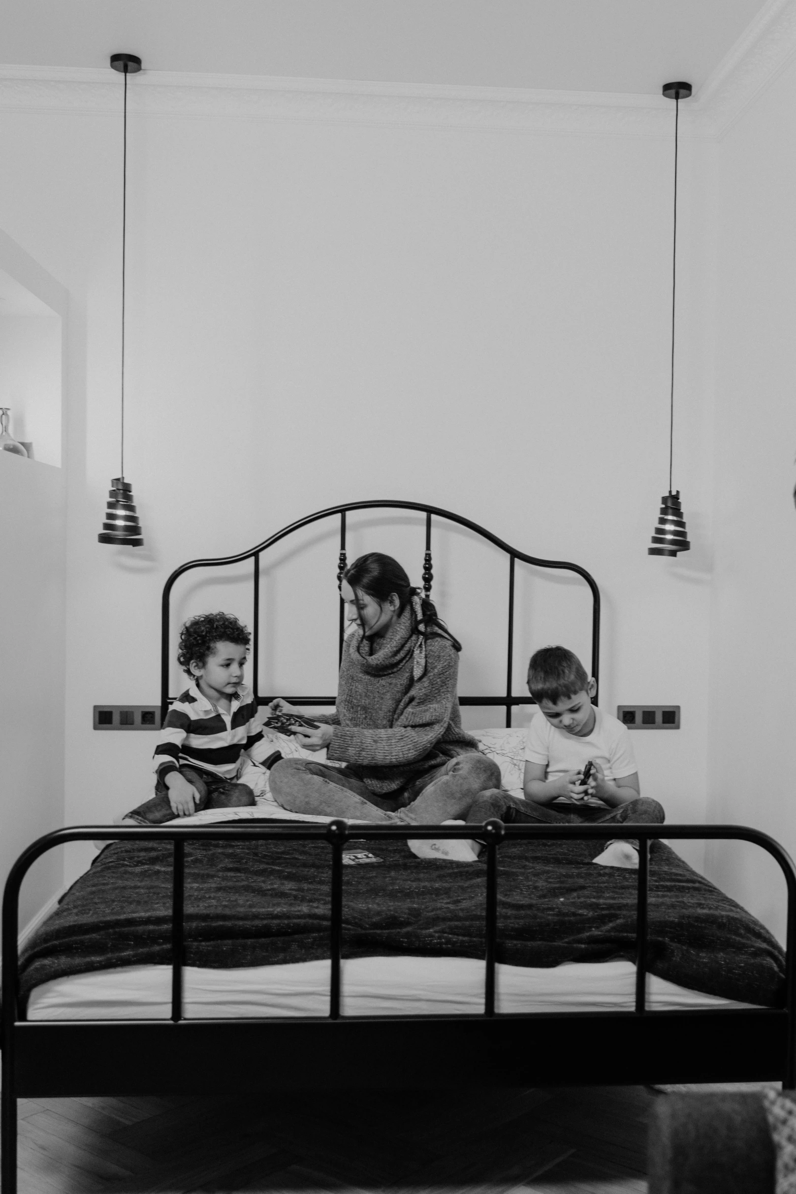 a woman reading a book to two children on a bed, a black and white photo, by Alessandro Allori, pexels contest winner, boy's room, - 9, good morning, late evening