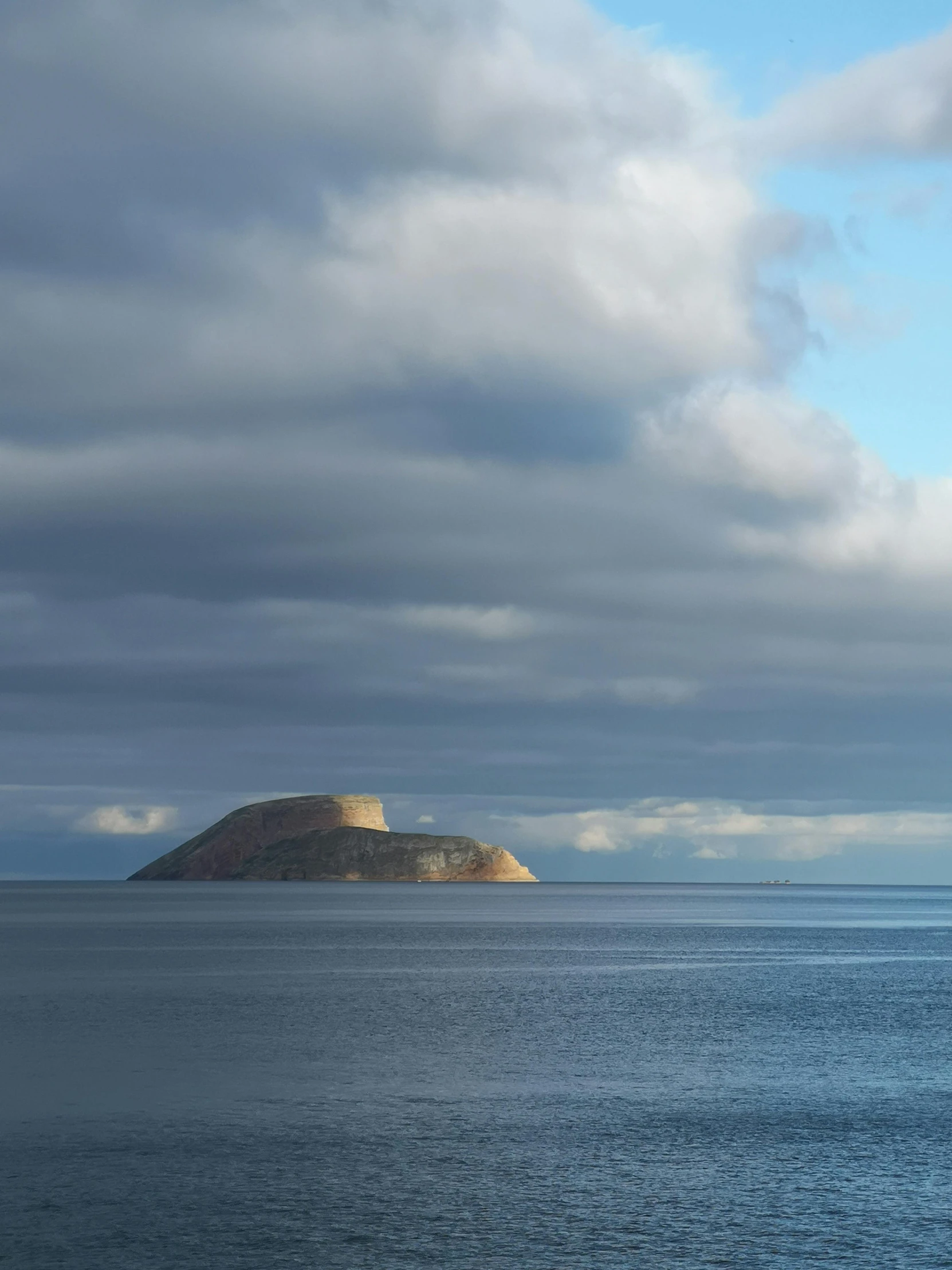 a large body of water with a small island in the distance, a photo, by Roar Kjernstad, 'silent hill ', ceremonial clouds, soft-sanded coastlines, today\'s featured photograph 4k