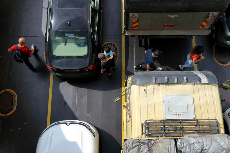 a group of people standing on the side of a road, top down view, vehicles, working, square