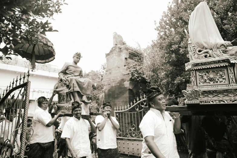 a group of men standing in front of a statue, a statue, unsplash, happening, bali, walk in a funeral procession, indore, ::