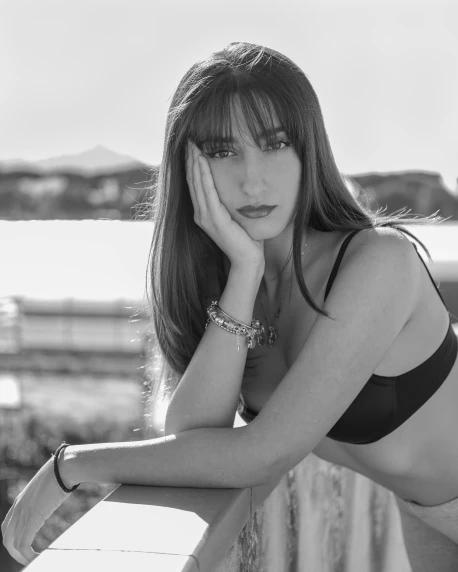 a black and white photo of a woman in a bikini, a black and white photo, unsplash, photorealism, brown hair and bangs, 🤤 girl portrait, 8k 50mm iso 10, beautiful view
