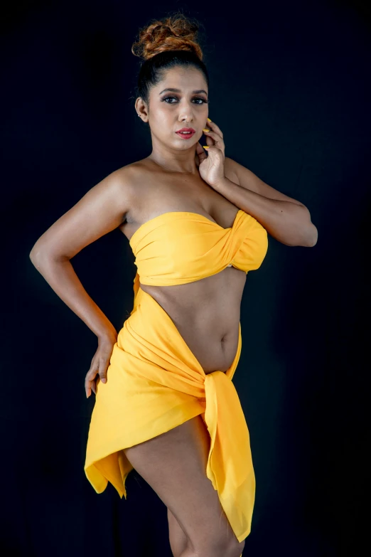 a woman in a yellow dress posing for a picture, flickr, wearing a towel, attire: bikini, fashion shoot 8k, light-brown skin