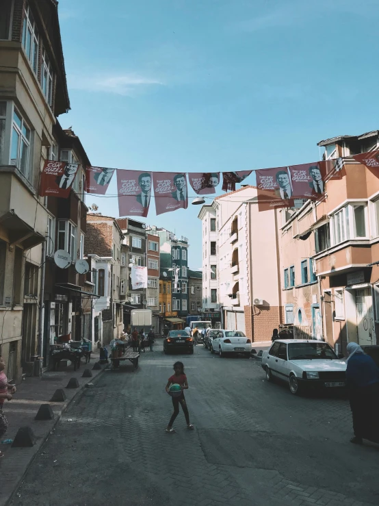 a person riding a skateboard down a street, by Ismail Acar, laundry hanging, turkish and russian, 4k photo”