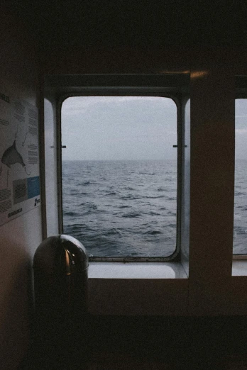 a couple of windows with a view of the ocean, a picture, by Christen Dalsgaard, unsplash, romanticism, ship interior, lofi album art, whales, 3 5 mm still photo
