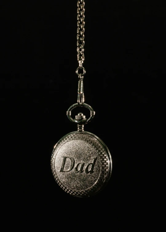 a silver pocket watch with the word dad on it, an engraving, by Paul Davis, multi-part, thumbnail, [ cinematic, demur