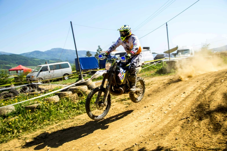 a man riding a dirt bike down a dirt road, tournament, janapese, profile image, square