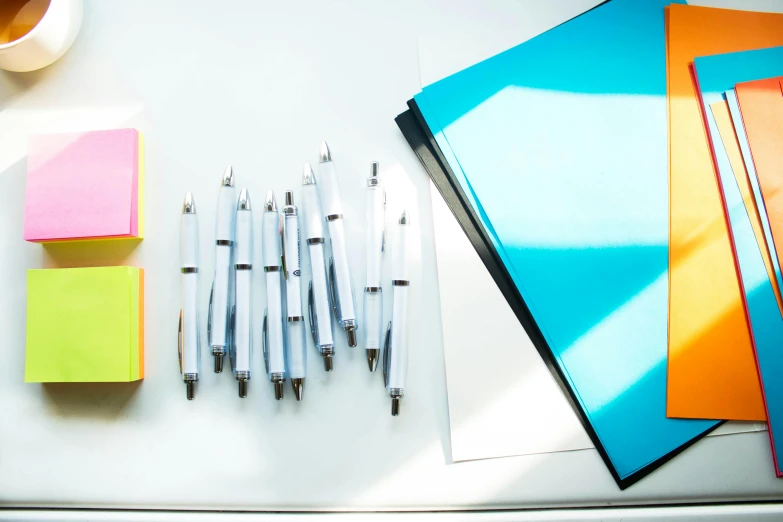 a variety of office supplies laid out on a desk, by Daniel Gelon, unsplash, process art, white cyan, sunlight, reflective material, 15081959 21121991 01012000 4k