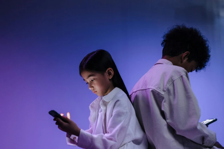 a couple of people standing next to each other holding cell phones, trending on pexels, incoherents, purple ambient light, tiny girl looking on, caring fatherly wide forehead, game