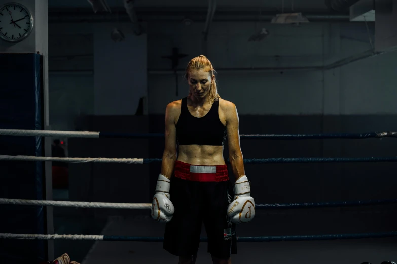 a female boxer standing in a boxing ring, a portrait, by David Begbie, pexels contest winner, hyperrealism, [ theatrical ], sydney hanson, britt marling style 3/4, production photo