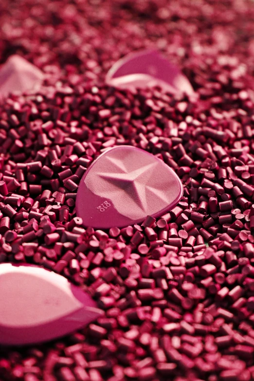 a close up of a bunch of rocks and gravel, a digital rendering, by Jason Felix, plasticien, rich deep pink, made of nanomaterials, rock star, candid photograph