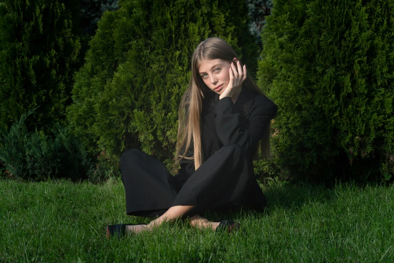 a woman sitting in the grass talking on a cell phone, an album cover, by Julia Pishtar, pexels contest winner, black outfit, sergey krasovskiy, posing for a picture, 15081959 21121991 01012000 4k