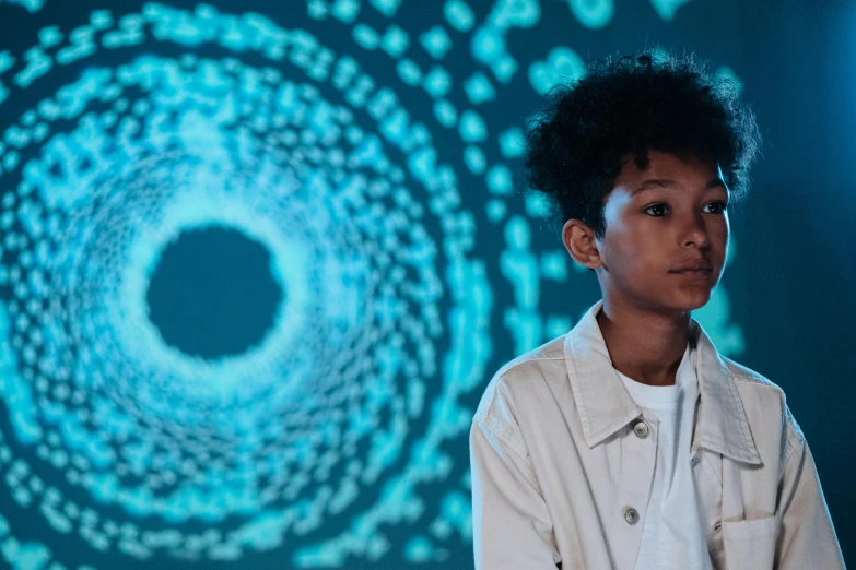 a young boy standing in front of a computer screen, trending on unsplash, afrofuturism, fractal wave interference, portrait of willow smith, entering a quantum wormhole, ignant