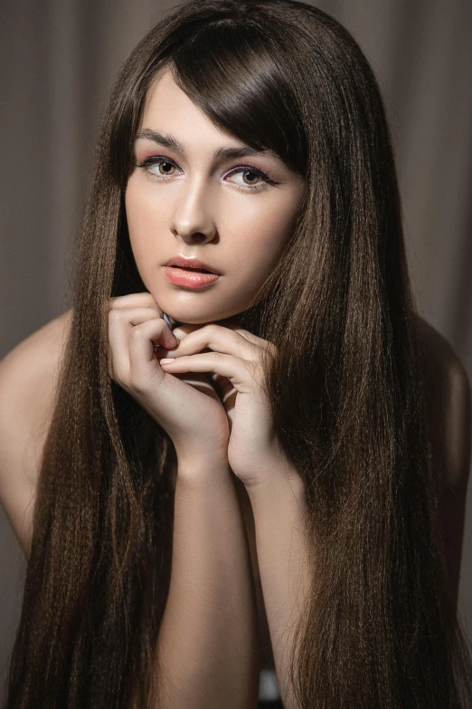 a woman with long brown hair posing for a picture, by Ivan Grohar, soft hair, hands on face, high quality image, half - length photo