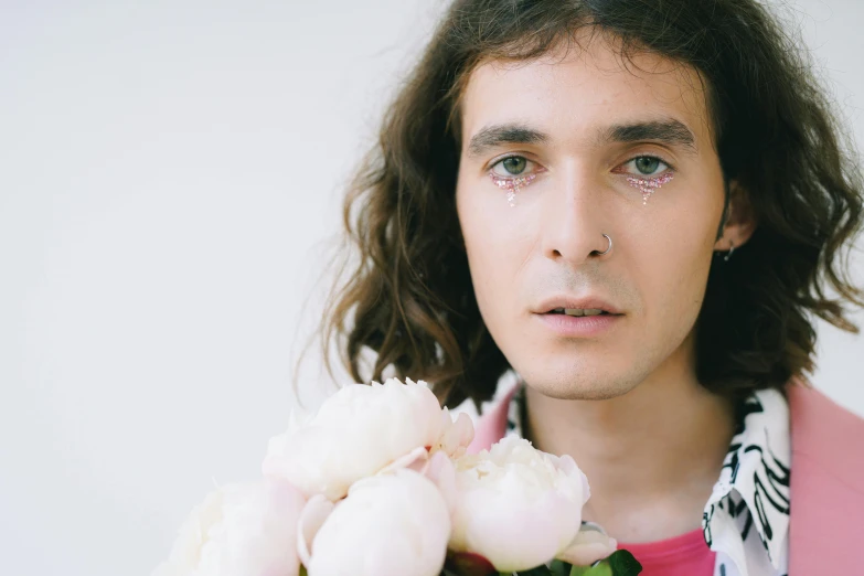 a man with long hair holding a bunch of flowers, an album cover, trending on pexels, intricate heterochromia sad, robert sheehan, portrait image, tears