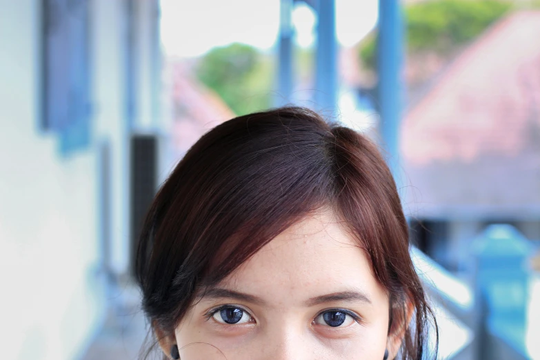 a close up of a person on a cell phone, inspired by Ni Yuanlu, unsplash, photorealism, brown hair and large eyes, malaysian, avatar image, shot on sony a 7