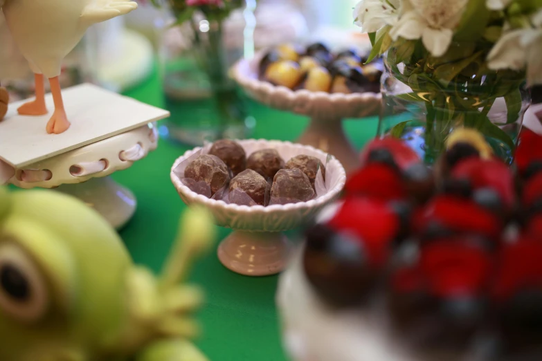 a close up of a plate of food on a table, cups and balls, chocolate, thumbnail, on display