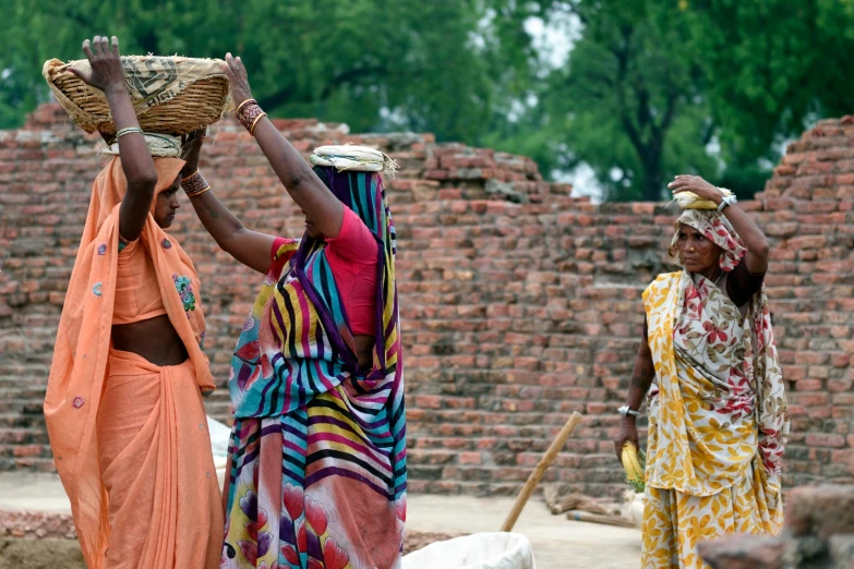 a group of women carrying baskets on their heads, pexels contest winner, samikshavad, avatar image, bright construction materials, high resolution photo