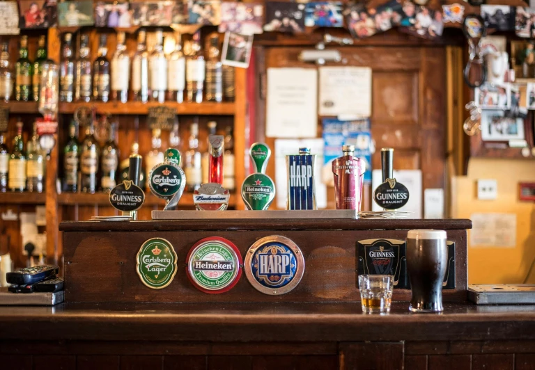 a bar filled with lots of different types of beer, by Joe Bowler, pexels contest winner, green arms, completely empty, old english, profile image