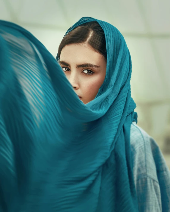 a woman with a blue scarf covering her face, a colorized photo, trending on pexels, arabesque, non binary model, looking serious, beautiful iranian woman, woman holding another woman