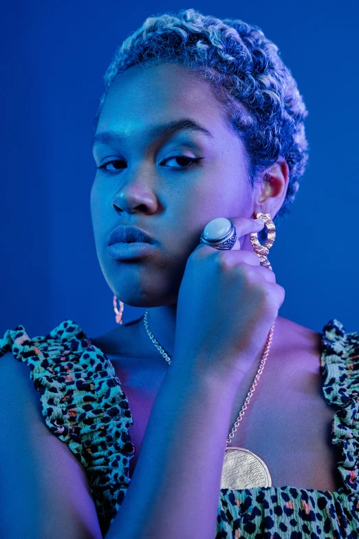 a woman with short hair wearing a leopard print dress, an album cover, trending on pexels, black and blue and gold jewelry, nettie wakefield, loish |, plus-sized