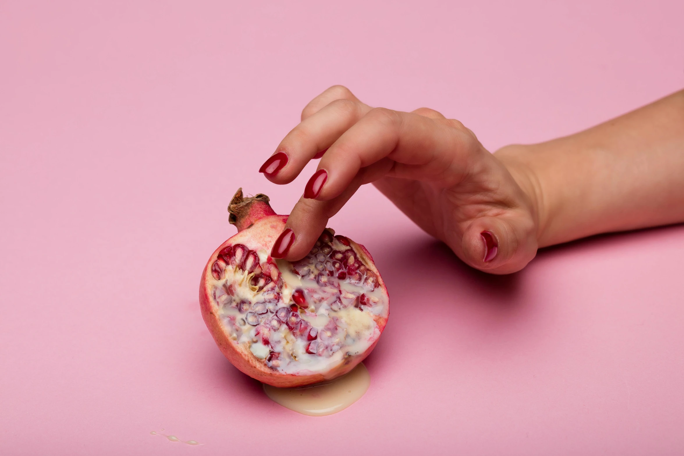 a woman's hand holding a half of a pomegranate, an album cover, inspired by Tracey Emin, hyperrealism, milk bar magazine, smooth pink skin, passion fruits, wolfy nail