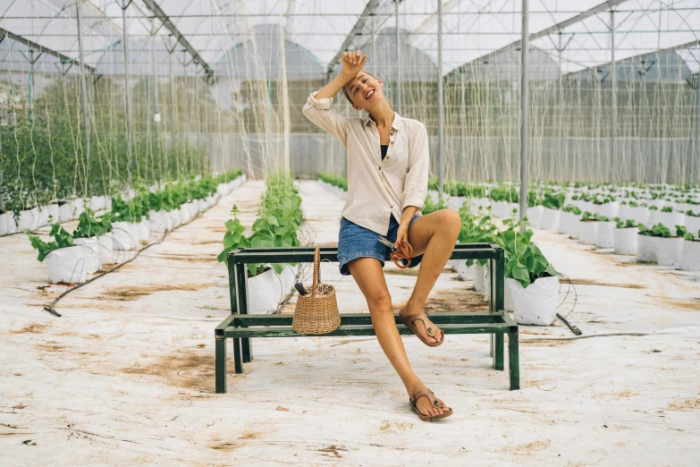 a woman sitting on a bench in a greenhouse, pexels contest winner, birkenstock sandals, tanned ameera al taweel, outside in a farm, full body image