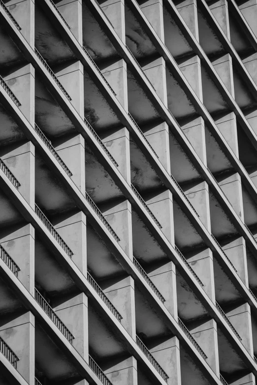 a black and white photo of a building, a black and white photo, inspired by Ned M. Seidler, unsplash, brutalism, lattice, square shapes, low detail, balconies