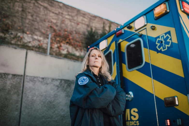 a woman standing in front of an ambulance, a portrait, pexels, renaissance, navy, izombie, shot on sony a 7, portrait n - 9