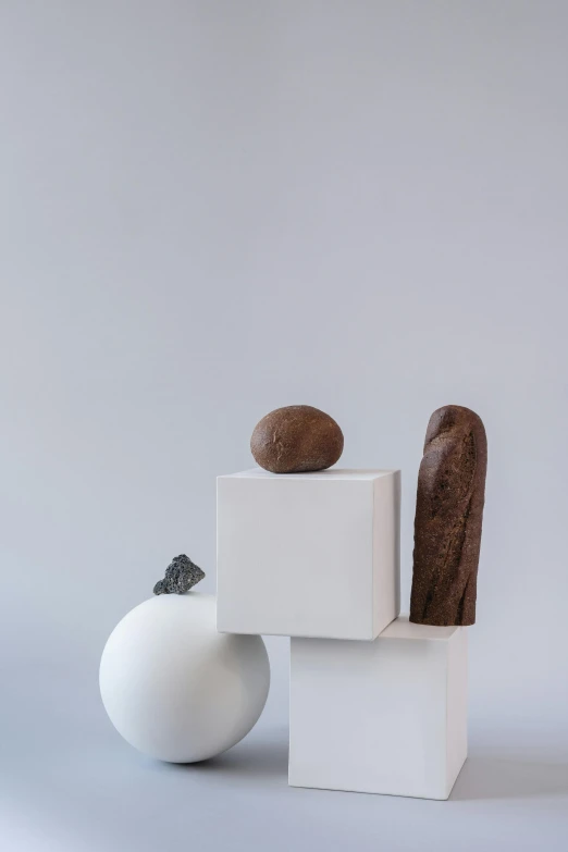 a couple of vases sitting next to each other, an abstract sculpture, new sculpture, chocolate, boulders, medium portrait, balance