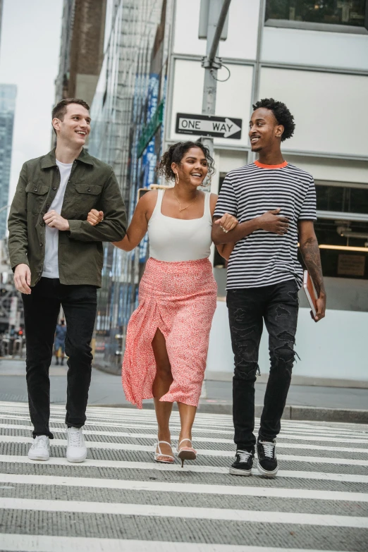 a group of people walking across a crosswalk, casual pose, promotional image, friends, diverse