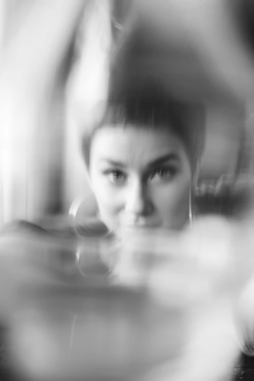 a black and white photo of a woman reflected in a mirror, blurry footage, andrea savchenko, ((portrait)), moleksandra shchaslyva