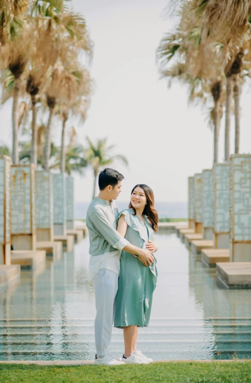 a man and woman standing next to each other in front of a body of water, luxurious environment, xiang duan, maternity feeling, beachfront