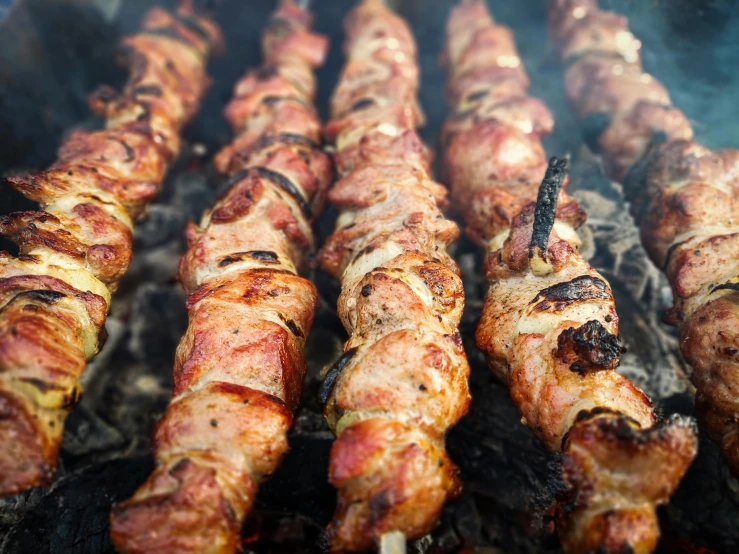 a close up of a bunch of meat on a grill, by Niko Henrichon, hurufiyya, instagram picture, cyprus, profile image, kebab