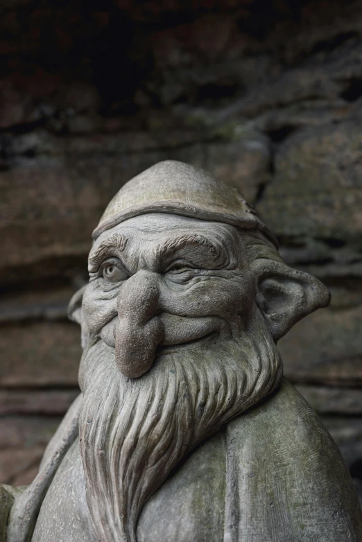 a statue of an old man with a beard, pexels contest winner, concrete art, cute little troll, winking, male wizard, looking away from camera