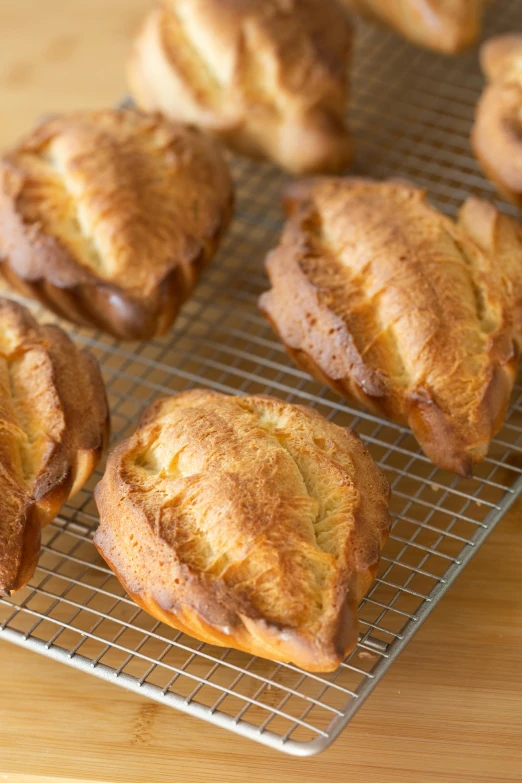 a bunch of pastries sitting on top of a cooling rack, hurufiyya, pointè pose, 6 pack, intricate wrinkles, traditional medium