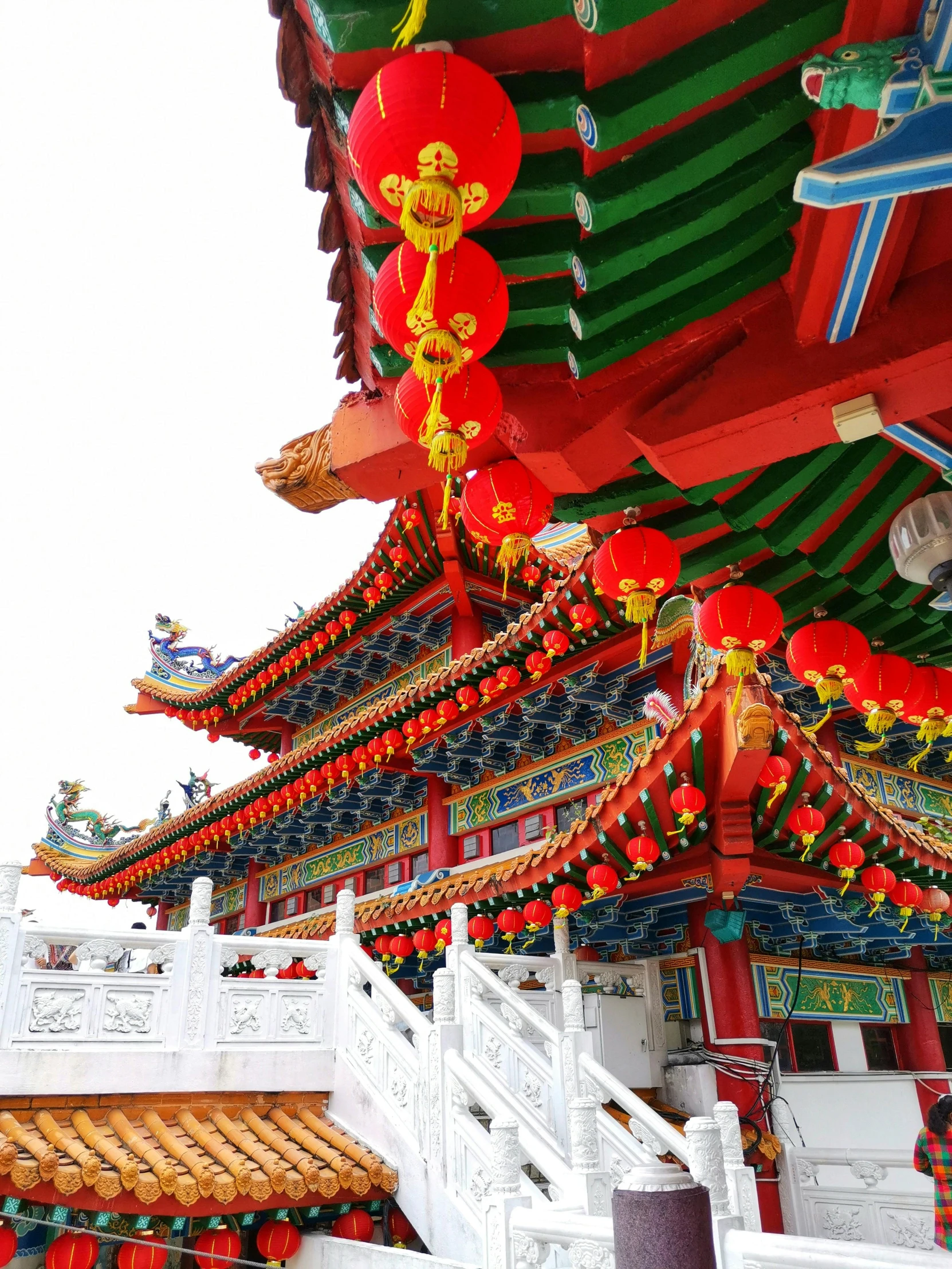 a building with a lot of decorations on top of it, inspired by Ju Lian, pexels contest winner, white and red color scheme, multi colour, pavilion, 💣 💥💣 💥