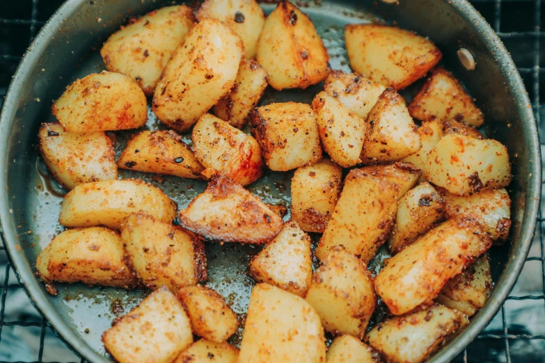 a pan filled with cooked potatoes on top of a stove, by Julia Pishtar, best fries, thumbnail, breakfast, close up image