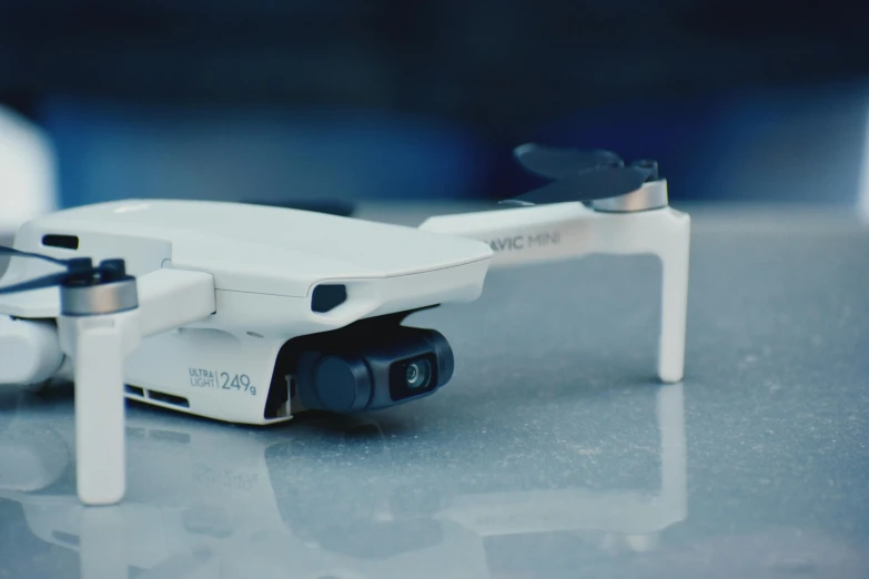 a small white drone sitting on top of a table, tech glasses, shot with sony alpha 1 camera, medium close - up ( mcu ), video still