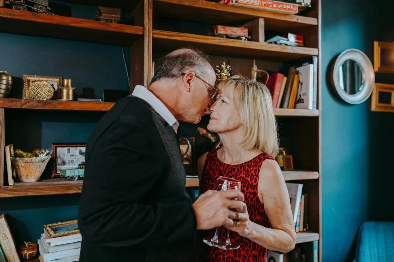 a man and a woman sharing a glass of wine, a portrait, by Gwen Barnard, pexels contest winner, private press, kissing together cutely, 5 5 yo, wearing festive clothing, standing elegantly