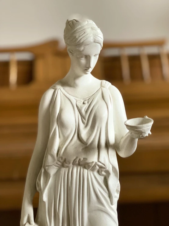 a statue of a woman holding a cup, inspired by Theophanes the Greek, neoclassicism, holding a candle holder, the goddess artemis smirking, full product shot, linen