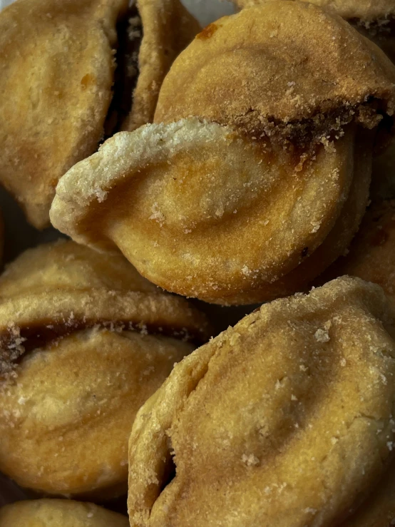 a pile of pastries sitting on top of a white plate, inspired by Ödön Márffy, reddit, renaissance, neck zoomed in from lips down, detailed product image, crispy buns, seventies