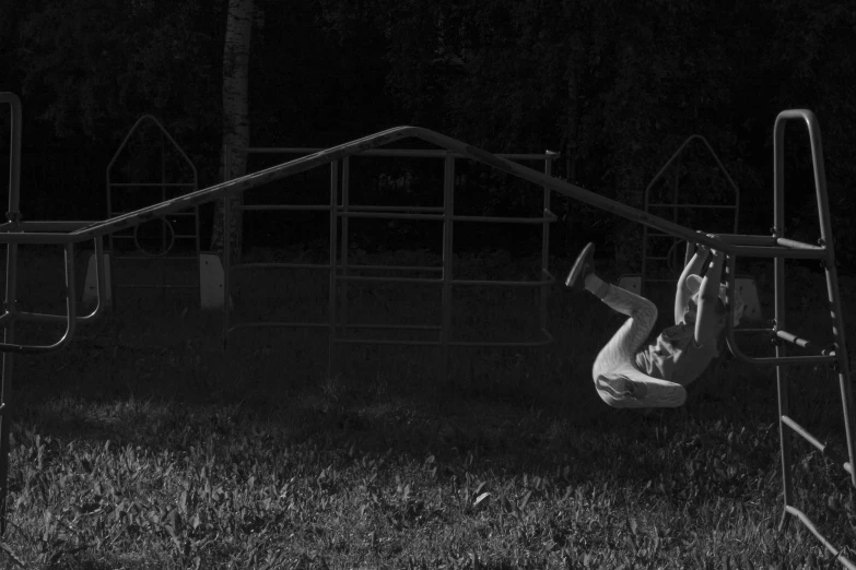 a black and white photo of a person on a swing, crawling, summer night, kickflip, vfx shot