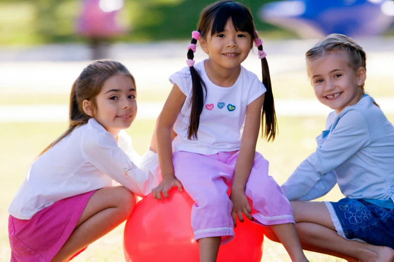 three little girls sitting on top of a red ball, pexels contest winner, school curriculum expert, sydney park, handsome girl, balloon