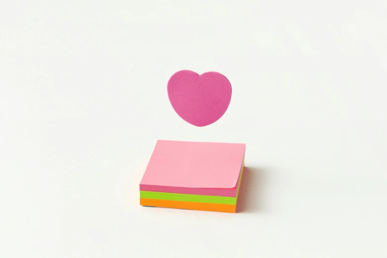 a piece of paper with a heart sticking out of it, trending on pexels, square sticker, fluorescent colours, notes, set against a white background
